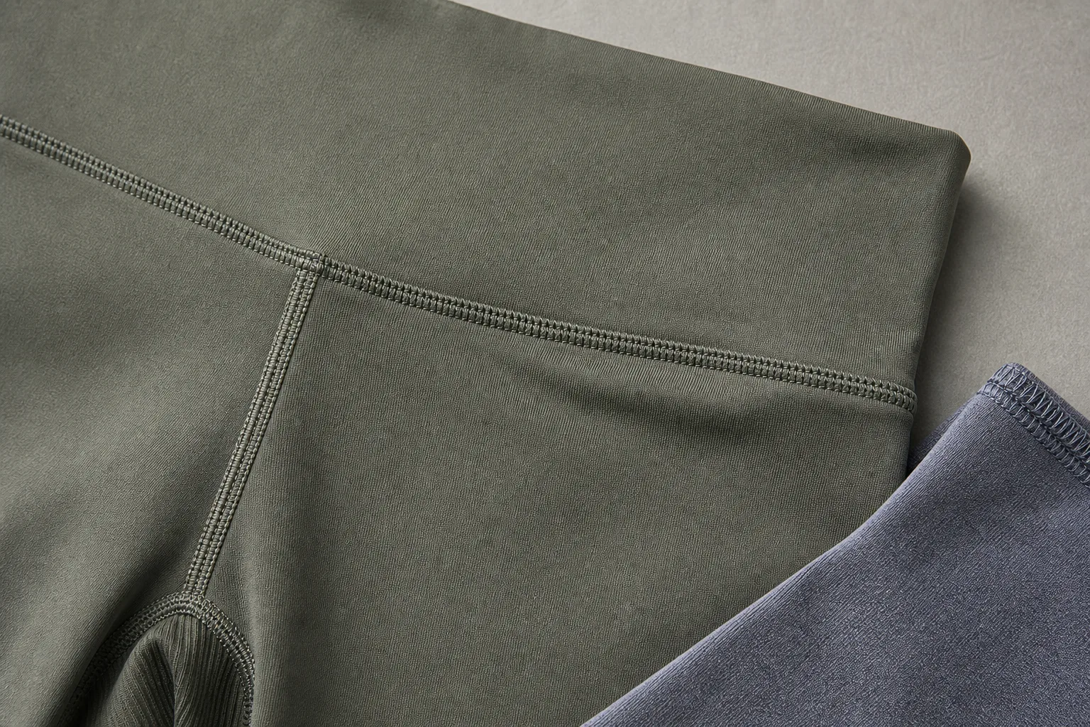Yoga apparel waistband seam detail with fabric texture and stitching