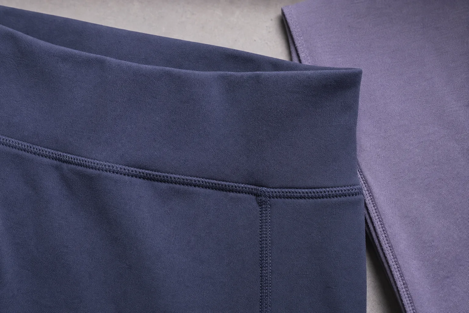 Yoga apparel waistband seam detail with fabric texture and stitching