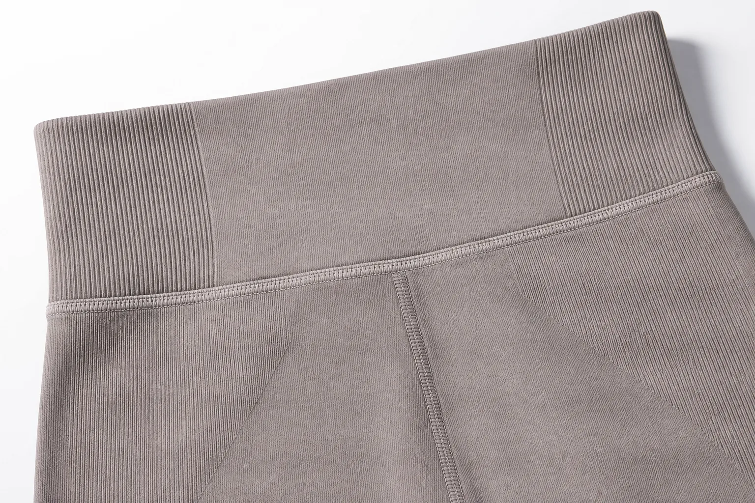 Seamless yoga legging close-up showing waistband and knit support zones