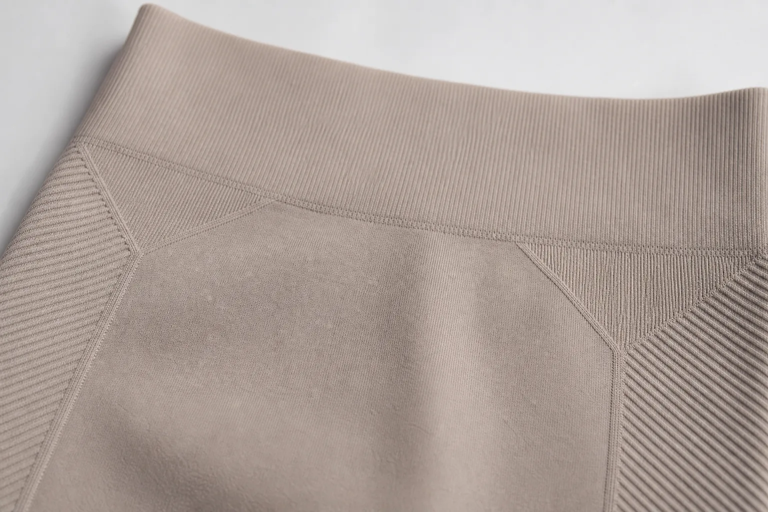 Seamless yoga legging close-up showing waistband and knit support zones